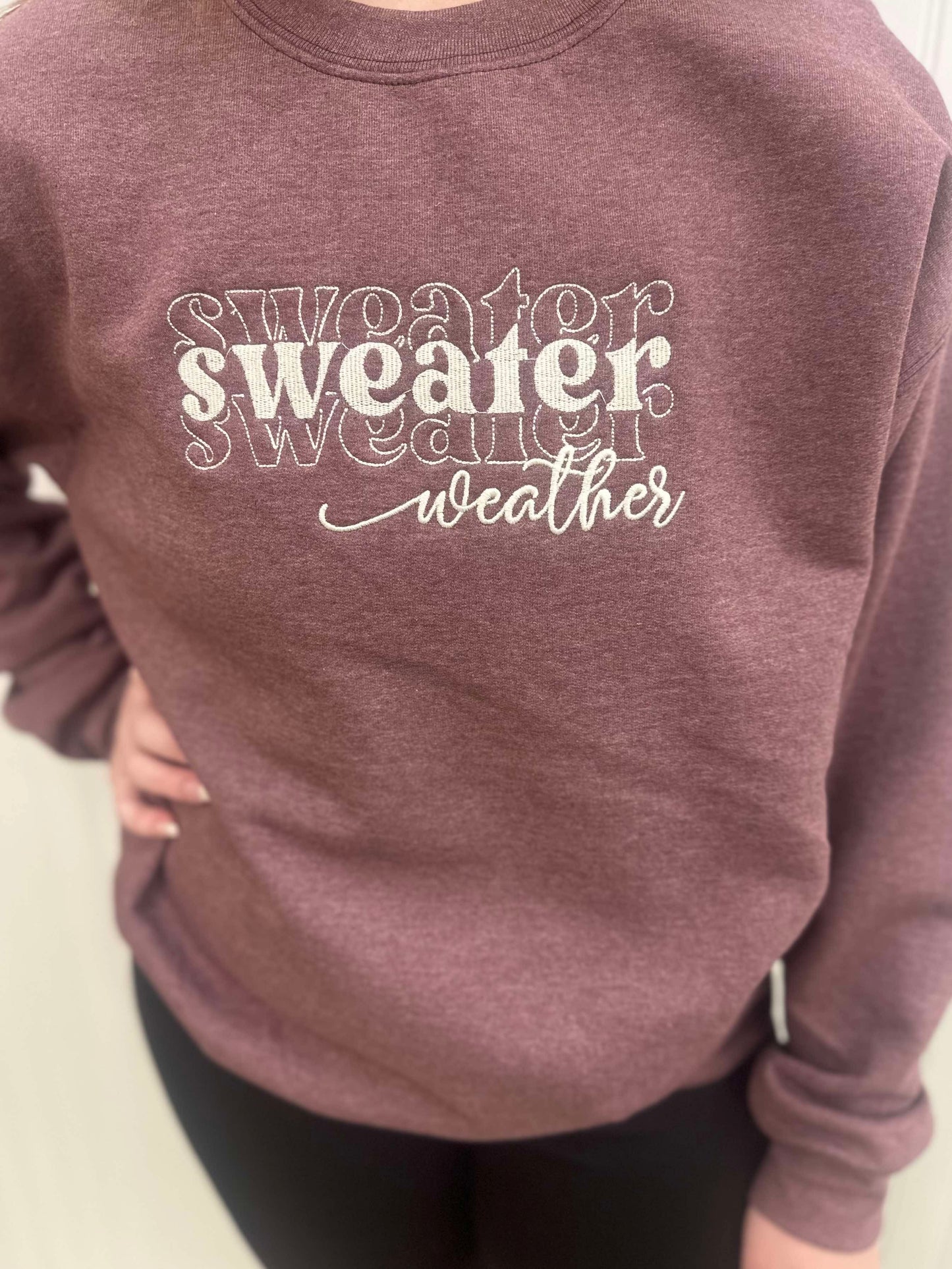 maroon sweater with sweater weather embroidered on it